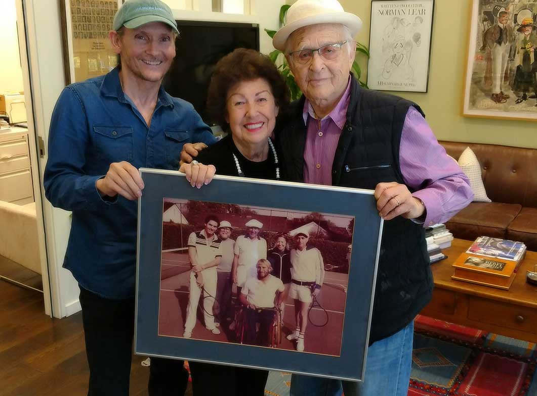 Chet Cooper, Fern Field and Norman Lear. Fern giving Norman a nostalgic picture of an epic day on the tennis court.